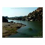 Massive boulders line the river, in the mystical town of Hampi, India